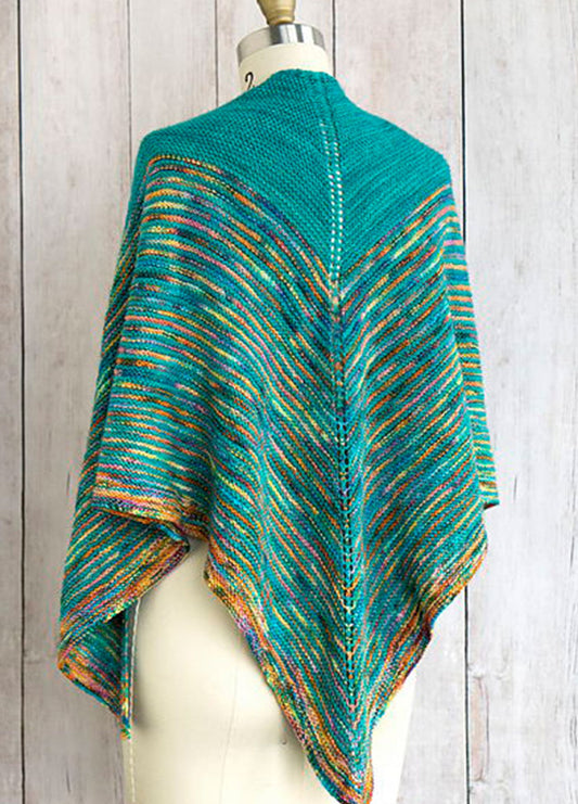 Allspice Shawl draped on a mannequin, featuring a vibrant V-shaped design in teal, orange, yellow, and blue with a curved edge and central spine.