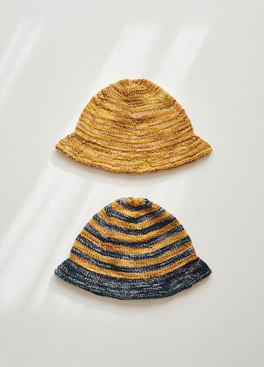 Two Delmira Hats: one solid yellow, one striped yellow and dark blue, displayed together.