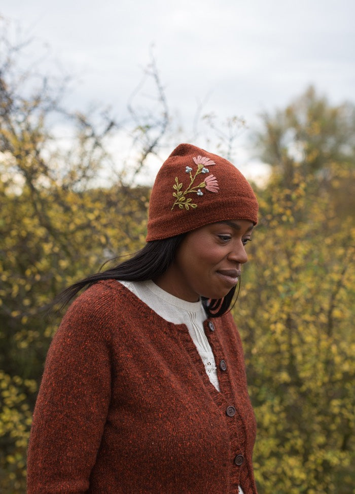 Tussie Mussie: floral embroidery on rust-colored knit hat paired with matching cardigan.