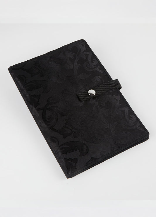 Black knitting case with a floral pattern, designed to securely hold and display crafting patterns and charts for easy access.