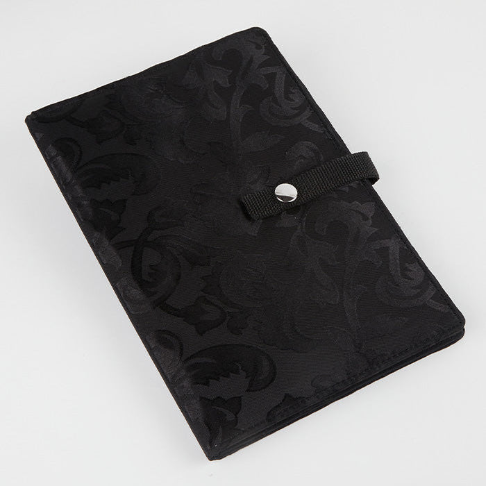 Black knitting case with a floral pattern, designed to securely hold and display crafting patterns and charts for easy access.