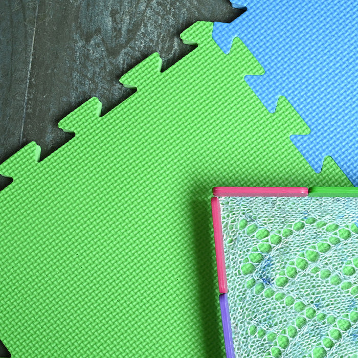 Colorful puzzle mat featuring green and blue pieces, designed for easy assembly and versatile project sizes.