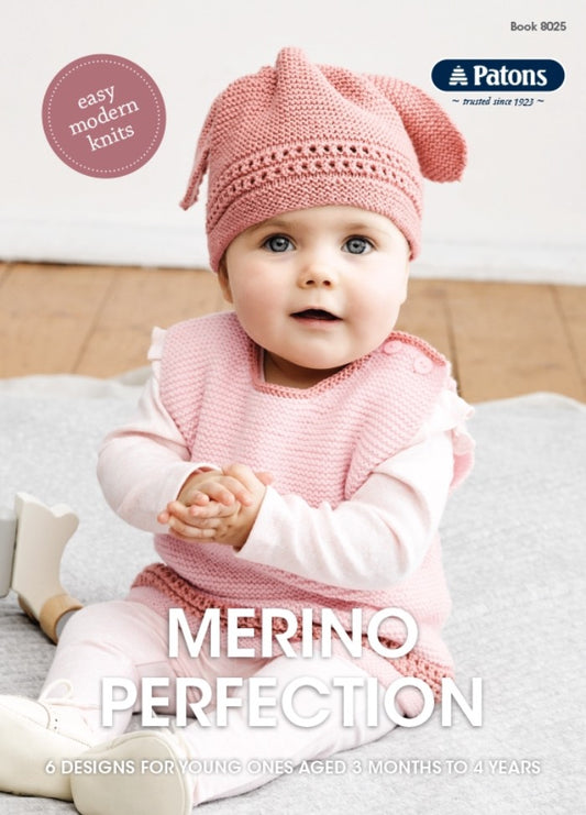 A baby wearing a pink knitted outfit and hat sits on a blanket indoors. The image conveys a cozy and gentle tone, promoting "Merino Perfection" knitting designs.
