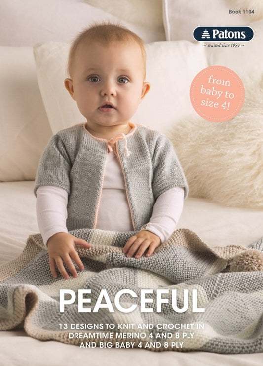A baby wearing a soft, gray knit cardigan sits on a bed with a pastel knitted blanket, embodying a calm and cozy atmosphere. Text: "Peaceful, 13 designs to knit and crochet."