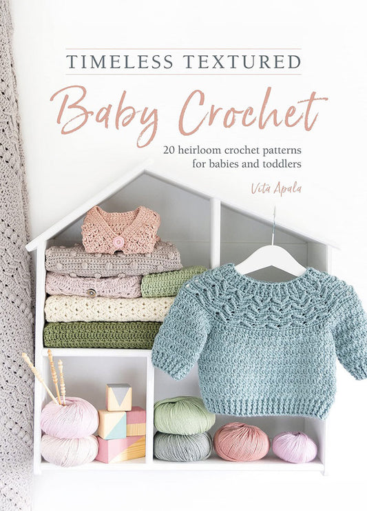 Cover of Timeless Textured Baby Crochet, featuring a soft, pastel-toned crochet blanket draped over a wooden chair, with a delicate lace pattern. The title is displayed in elegant serif font at the top, with the author's name beneath.