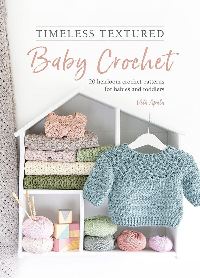 Cover of Timeless Textured Baby Crochet, featuring a soft, pastel-toned crochet blanket draped over a wooden chair, with a delicate lace pattern. The title is displayed in elegant serif font at the top, with the author's name beneath.
