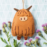 Crafted toy holding in a flower background
