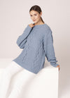 Knitted vest with nautical stripes, styled with denim for a coastal summer look.