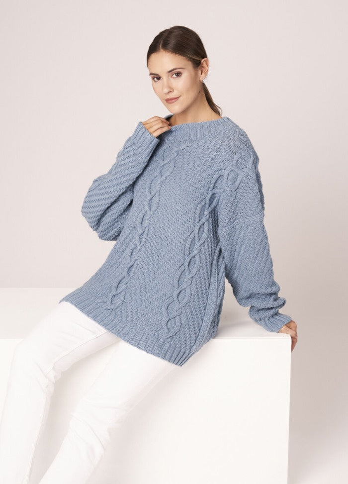 Knitted vest with nautical stripes, styled with denim for a coastal summer look.