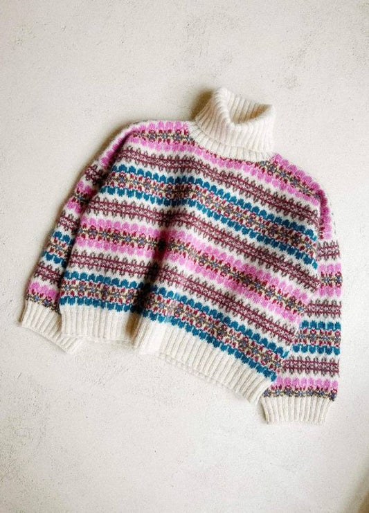 Cozy turtleneck sweater with colourful, intricate horizontal stripes of pink, blue, and brown on a cream background, exuding warmth and comfort.