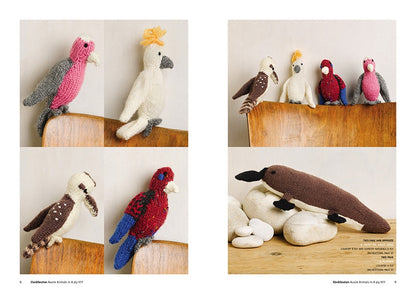 Knitted birds perch on a wooden chair, showcasing vibrant colors like pink, red, and blue. A knitted platypus rests on white stones nearby. Cozy and whimsical.