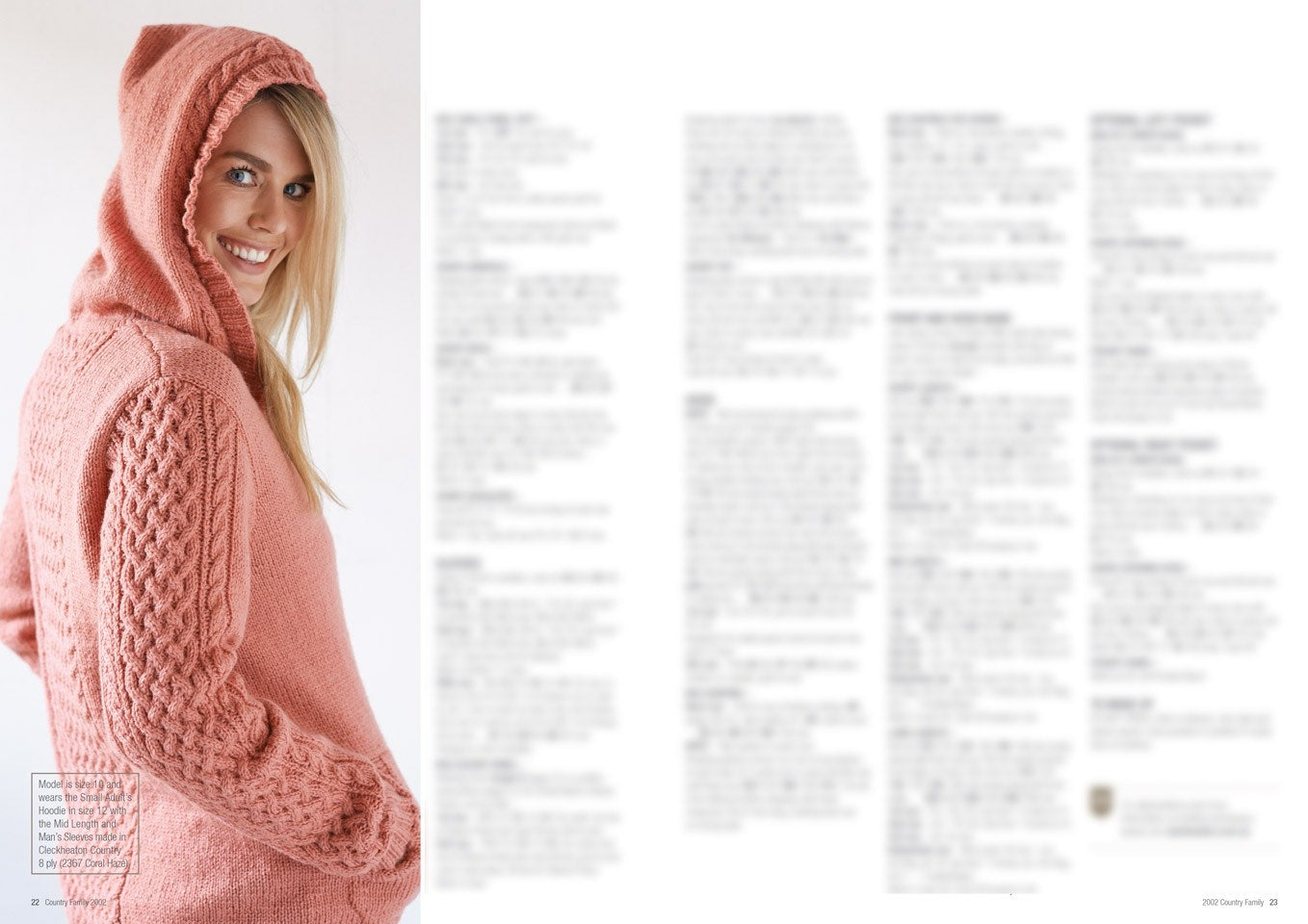 A woman in a pink knitted hoodie with intricate cable patterns smiles while looking at the camera. The right side shows blurred text, suggesting a magazine layout.