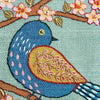 Colorful embroidered bird on a branch with flowers