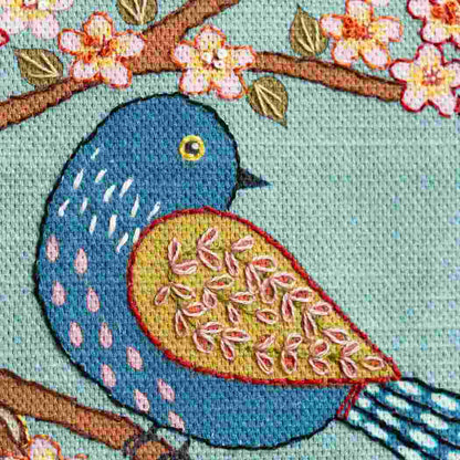 Colorful embroidered bird on a branch with flowers