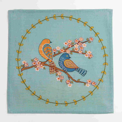 Decorative fabric panel with birds and floral design on a teal background