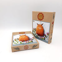 Two cardboard boxes with Highland Cow craft kit on a white background