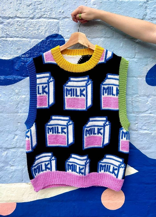 Colorful knitted vest with a milk carton pattern on a vivid mural background. Bright colors and playful design evoke a cheerful, whimsical tone.