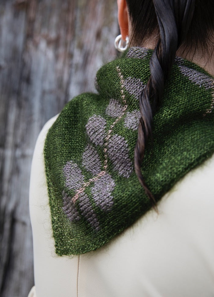 In The Wild Scarf': Green scarf with gray floral pattern, worn with twisted braid hairstyle and silver hoop earrings.