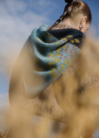 Under The Midnight Moon Scarf': Teal to dark blue gradient scarf with yellow leaf motifs and red dots, worn outdoors.