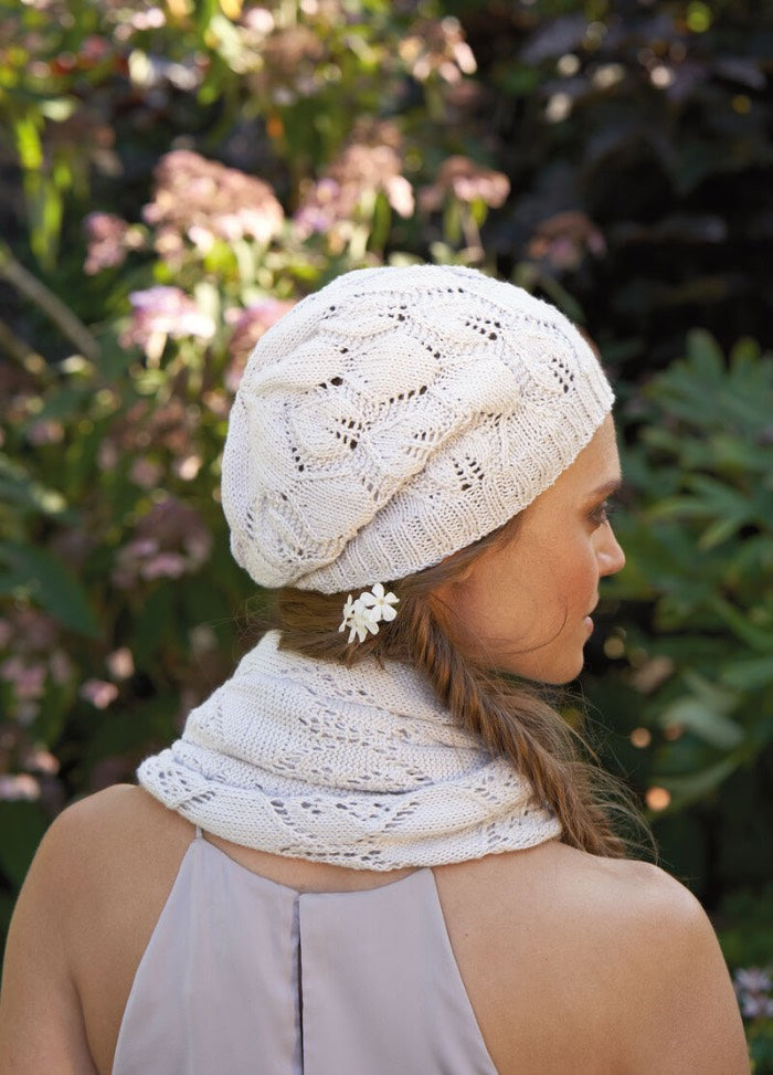 Delphine Hat knitting pattern, a matching lace accessory to the Delphine Poncho, featuring soft texture and garden-inspired design.