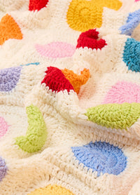 Crocheted Dot Blanket with a white base and colorful circular dots in red, orange, yellow, green, blue, purple, and pink, arranged in neat rows and columns – cheerful and playful handmade design.