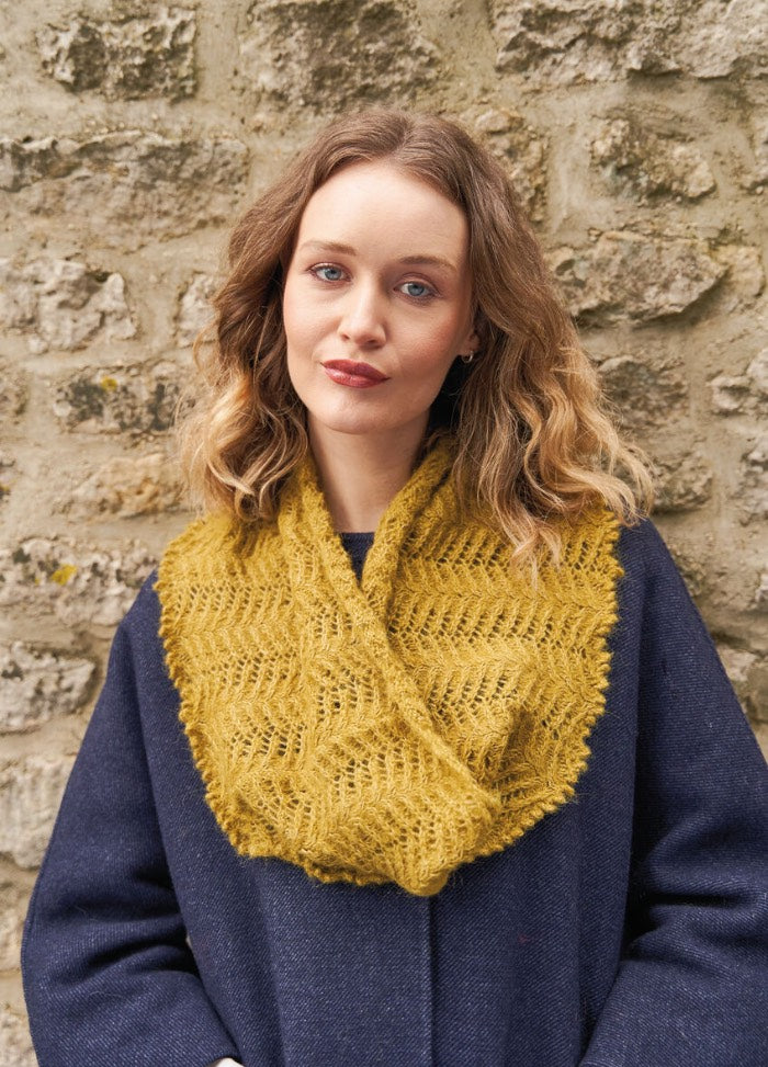 Soft cowl featuring interplaying cables and lace with a picot edge; knit in feather-light Alpaca Classic for warmth without weight.