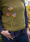 Fern: dried fern leaf motifs arranged on dark knit sweater as embroidery inspiration.