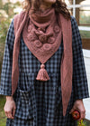 Ode to Autumn: pinkish-brown shawl with intricate knit patterns and tassel, evoking seasonal warmth.