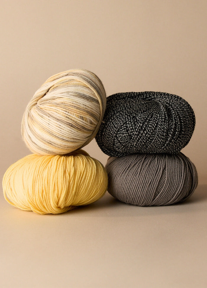 Three vibrant balls of 4ply merino wool yarn, perfect for baby blankets and various knitting and crochet projects.