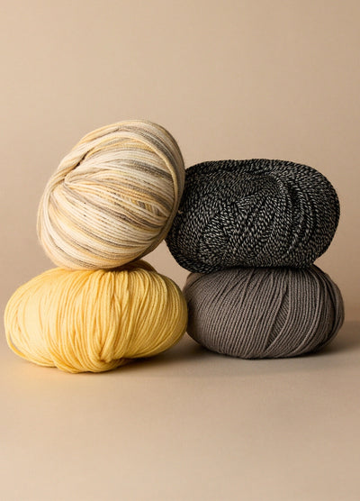 Three vibrant balls of 4ply merino wool yarn, perfect for baby blankets and various knitting and crochet projects.