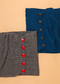 Two textured knit scarves are displayed on a beige background. One is charcoal gray with large red buttons, and the other is blue with brown buttons.