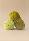 Two colourful balls of machine washable wool yarn displayed on a beige background, highlighting their 10ply weight and care instructions.