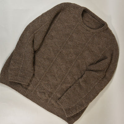 Flat lay of the Esther Sweater in brown knit with diamond texture, ribbed cuffs, hem, and neckline, displayed on a light surface.