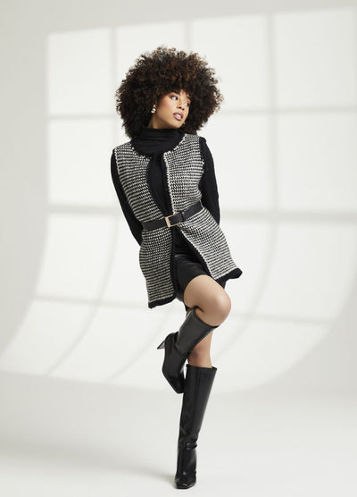 A person poses stylishly in a black and white houndstooth vest and knee-high boots, exuding confidence. The bright, grid-patterned background adds a modern touch.
