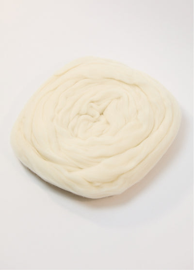 A white ball of Australian roving yarn on a white background, highlighting its fine Merino fibers and soft appearance.