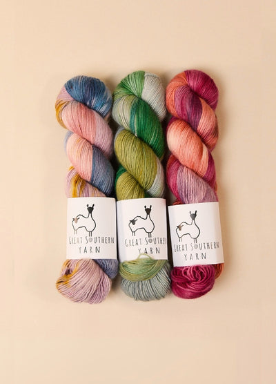 Three skeins of pink yarn labeled 'pink', showcasing soft, hand-dyed Australian merino wool for fingering weight projects.