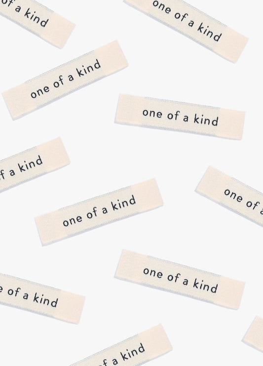 One of a Kind Sew-in Labels scattered