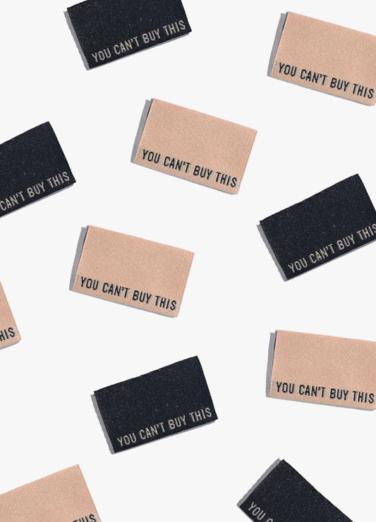 You Can't Buy This (Black and Cream) Sew-in Labels scattered