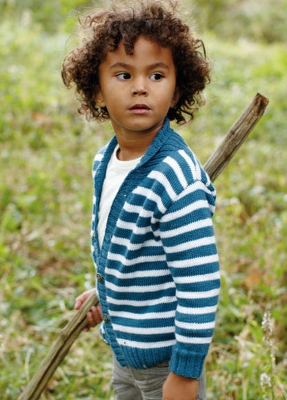 Child in blue and white striped Kaptain Cardigan over white shirt, holding stick outdoors.