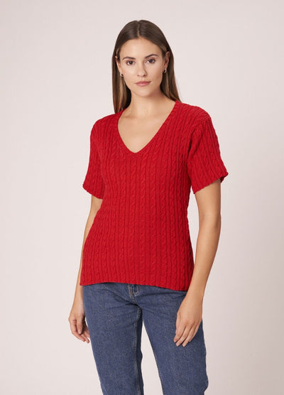 Woman in a breezy crochet-style cardigan with open stitchwork, perfect for warm weather.