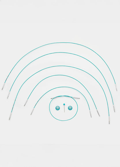 A set of teal knitting cables with a central circle, featuring a smooth coating and available in multiple lengths for easy knitting.