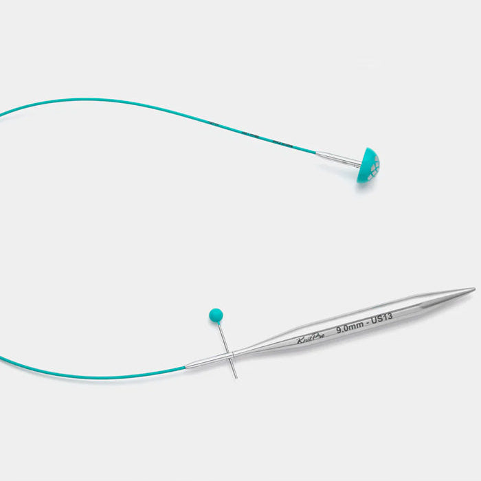 A knitting cable with a blue cord, crafted for precision cutting, featuring a teal smooth coating and flexible material.
