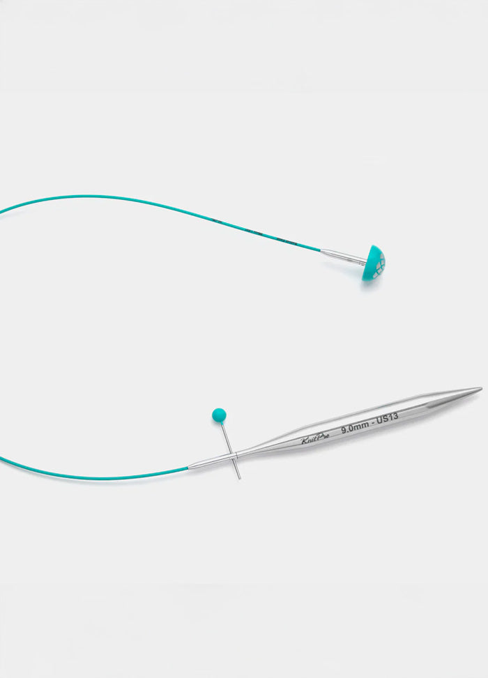 A knitting cable with a blue cord, crafted for precision cutting, featuring a teal smooth coating and flexible material.