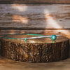  A wooden table features a blue knitting cable on its surface, emphasizing a neat and uncluttered appearance.
