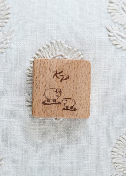 Charming wooden tape measure with a sheep and heart motif, combining contemporary style with everyday utility.