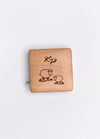 A beechwood box with a sheep motif and KP logo, housing a 150cm tape measure with metric and imperial markings.