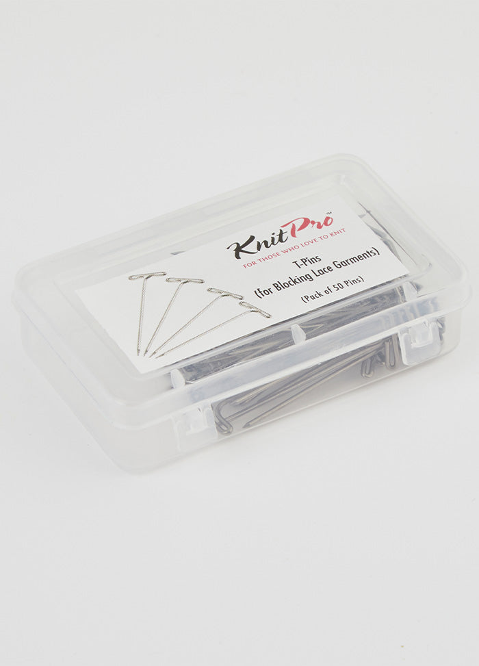 A plastic container featuring T-pins, designed for pinning lace shawls to create elegant scalloped edges