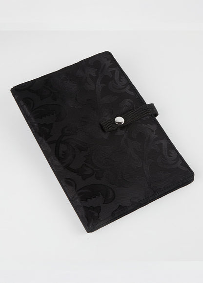 Black knitting case with a floral pattern, designed to securely hold and display crafting patterns and charts for easy access.