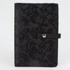 Black knitting bag with a floral pattern, designed to hold and display crafting patterns securely while working on projects.
