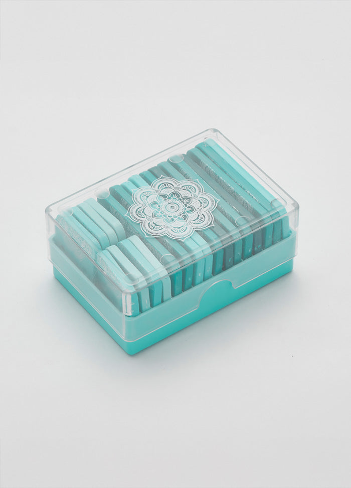 A clear box filled with 20 blue and white square Mindful Knit Blockers, featuring stainless steel pins for easy blocking.